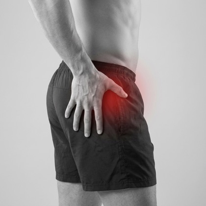 Man holding his hip, red highlight showing hip pain