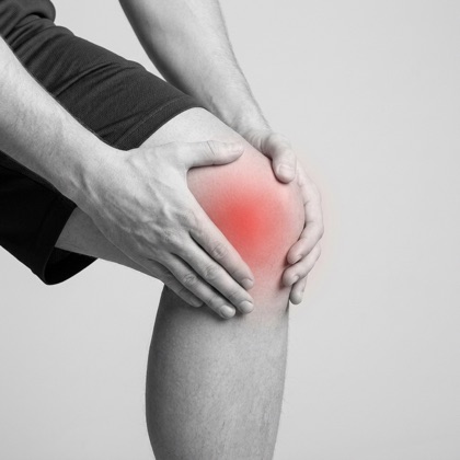 Man holding his knee, red highlight showing knee pain