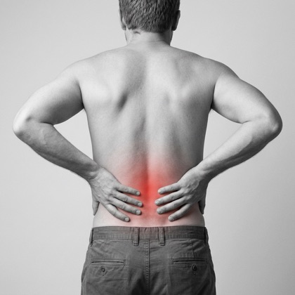 Man holding his lower back, red highlight showing lumbar pain